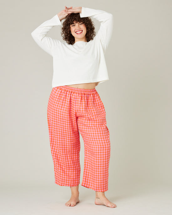 model wears tomato and pink check PJ trousers