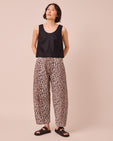 model wears tori leopard print denim jeans left