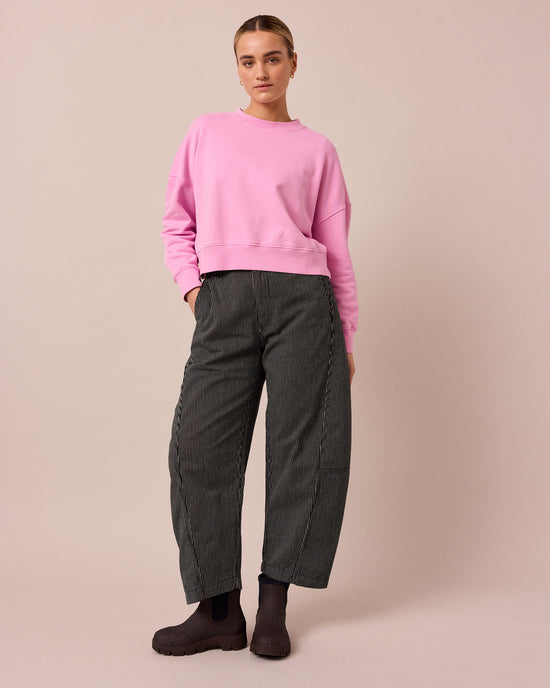 model wears tori black hickory stripe denim jeans left