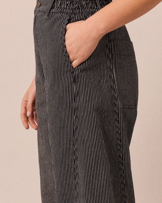 model wears tori black hickory stripe denim jeans right