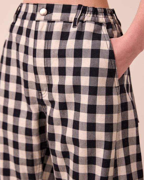 model wears tori black and white check denim jeans