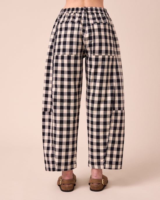 model wears tori black and white check denim jeans back