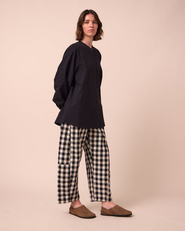 model wears tori black and white check denim jeans right