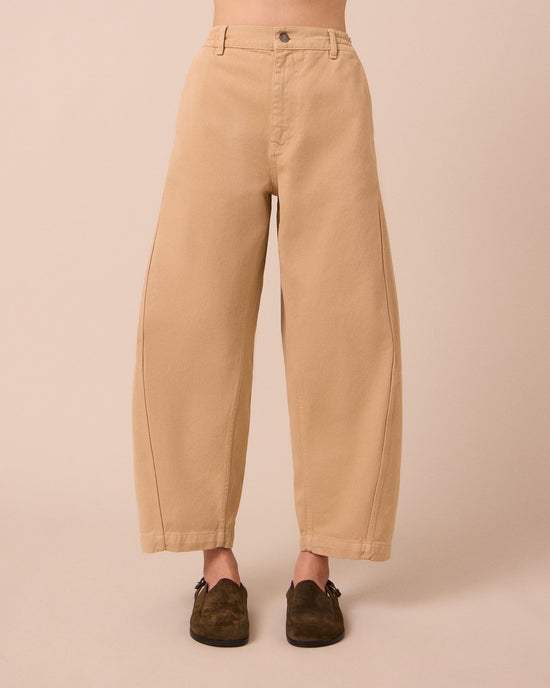 model wears tori sandstone denim jeans front