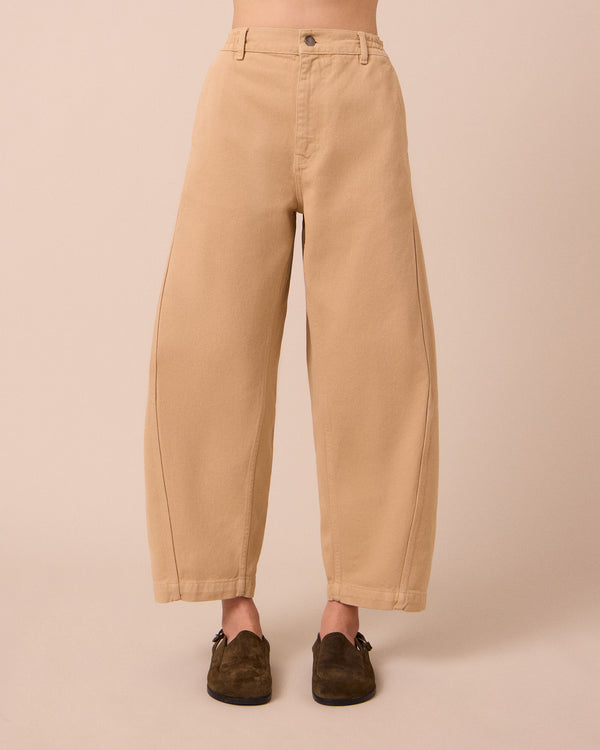 model wears tori sandstone denim jeans front