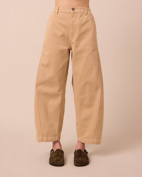 model wears tori sandstone denim jeans front