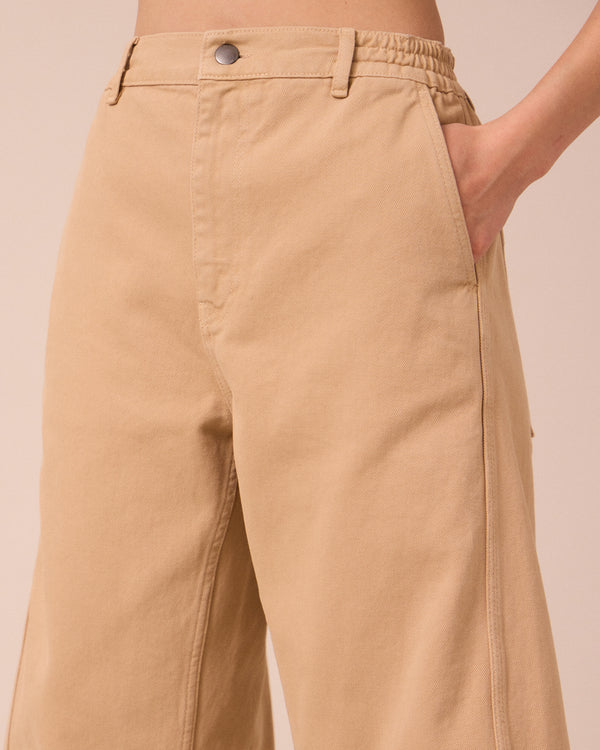 model wears tori sandstone denim jeans 