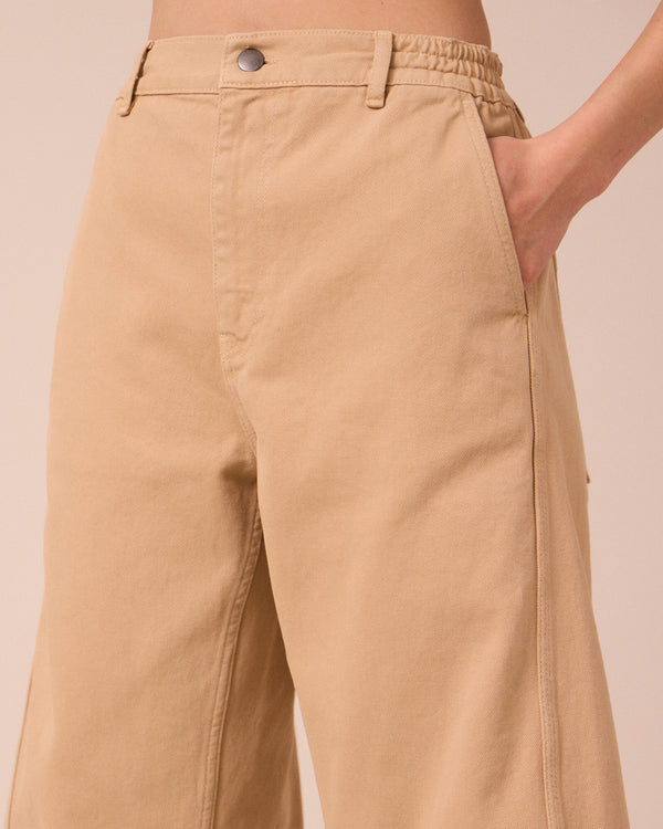 model wears tori sandstone denim jeans