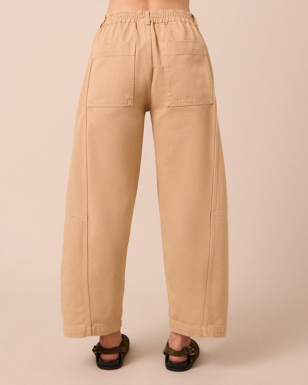 model wears tori sandstone denim jeans back