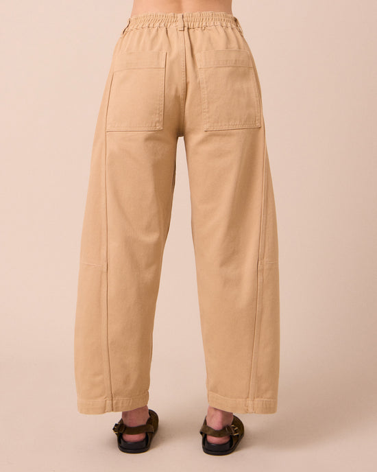 model wears tori sandstone denim jeans back