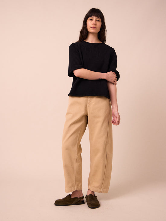 model wears tori sandstone denim jeans left