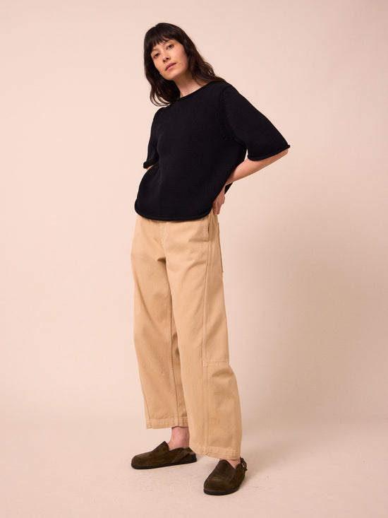 model wears tori sandstone denim jeans right