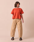 model wears tori sandstone denim jeans right