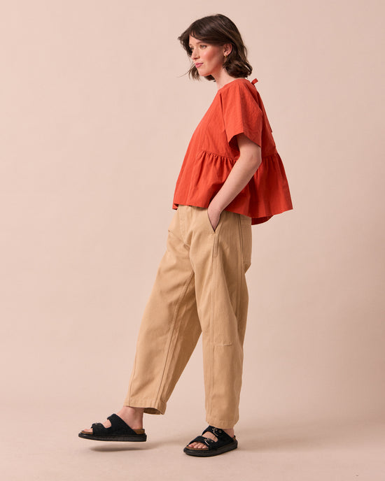 model wears tori sandstone denim jeans left