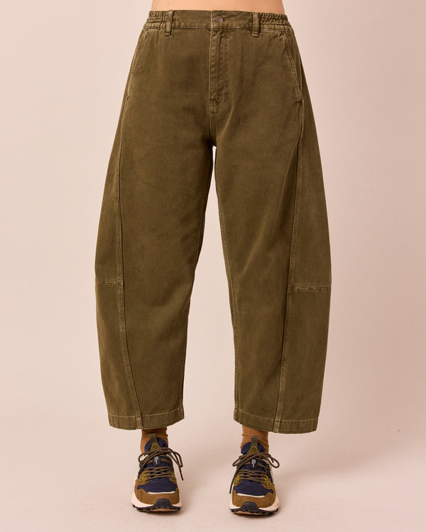 model wears tori olive denim jeans front