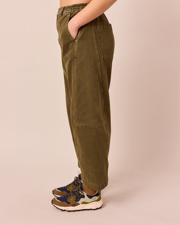 model wears tori olive denim jeans left