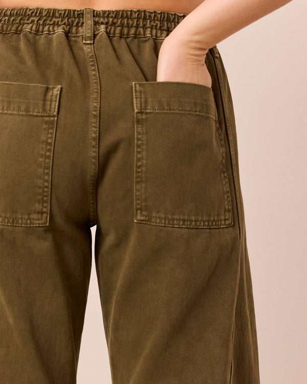 model wears tori olive denim jeans