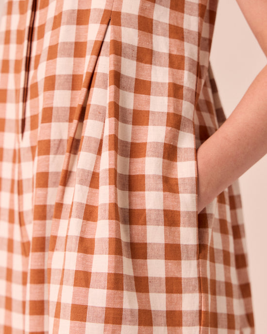 model wears tula amber check linen jumpsuit