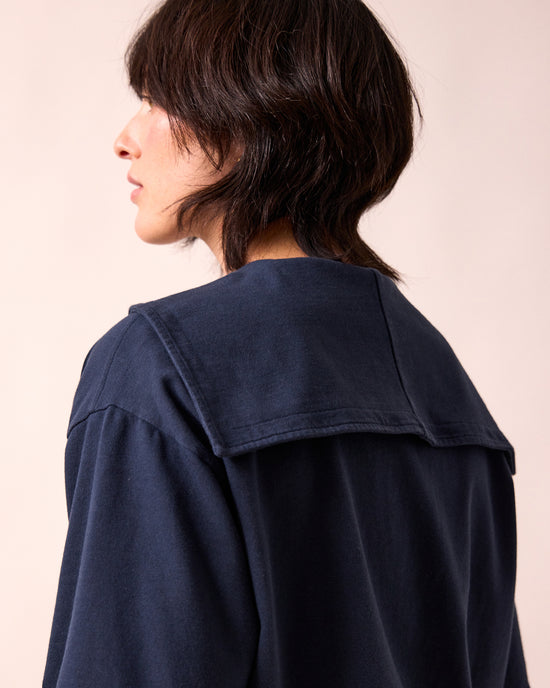 model wears uma navy jersey top