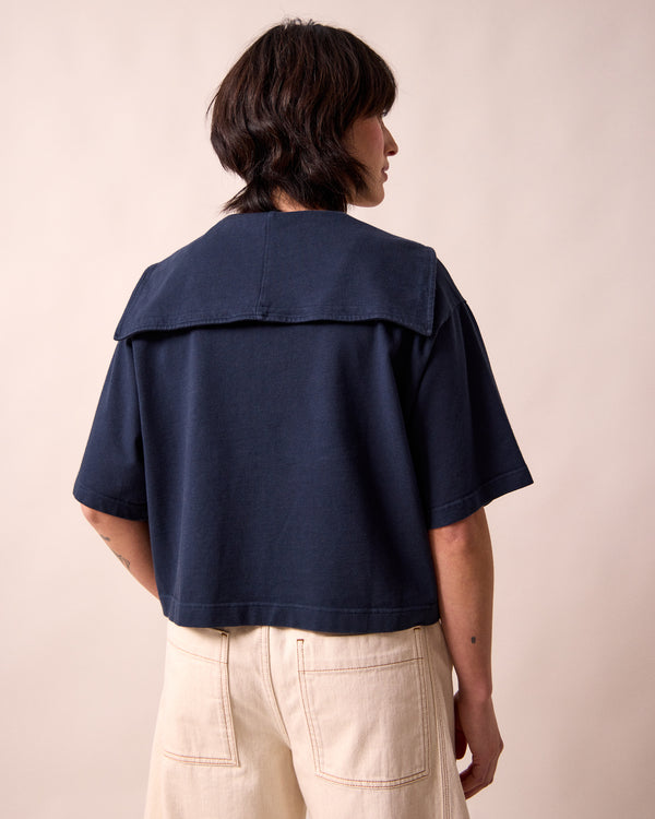model wears uma navy jersey top