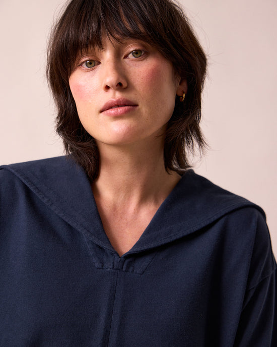 model wears uma navy jersey top