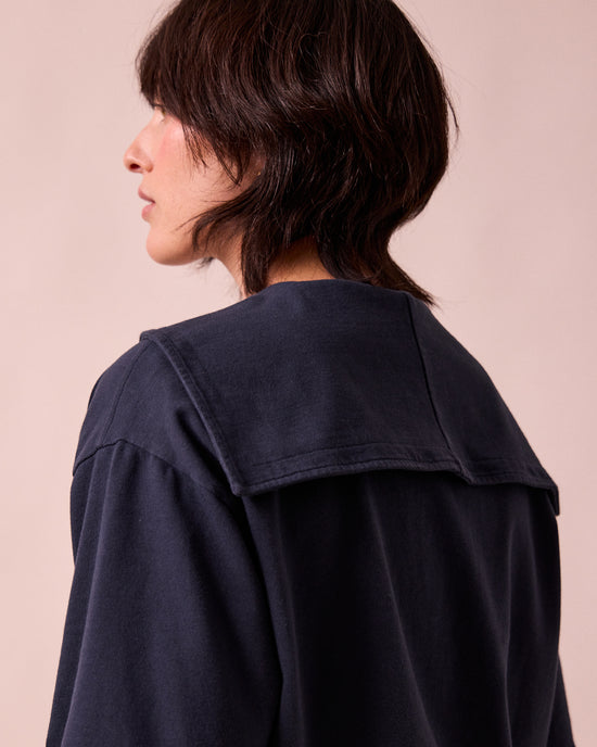 model wears uma navy jersey top