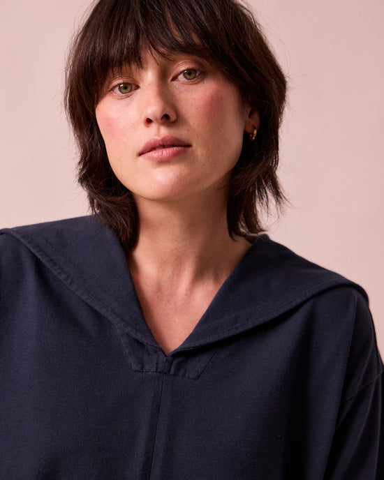 model wears uma navy jersey top