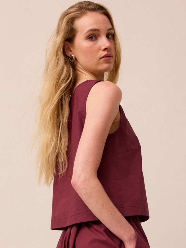 model wears esme burgundy poplin top