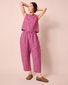 model wears mabel summer berry gingham linen trousers left