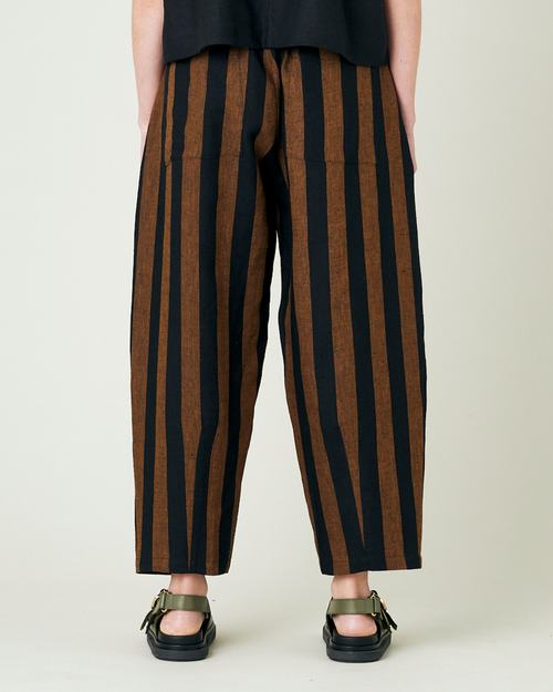 model wears rust stripe huxley trousers back