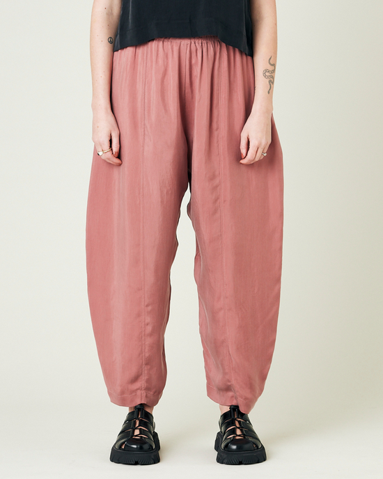 model wears dusty pink cupro trousers front