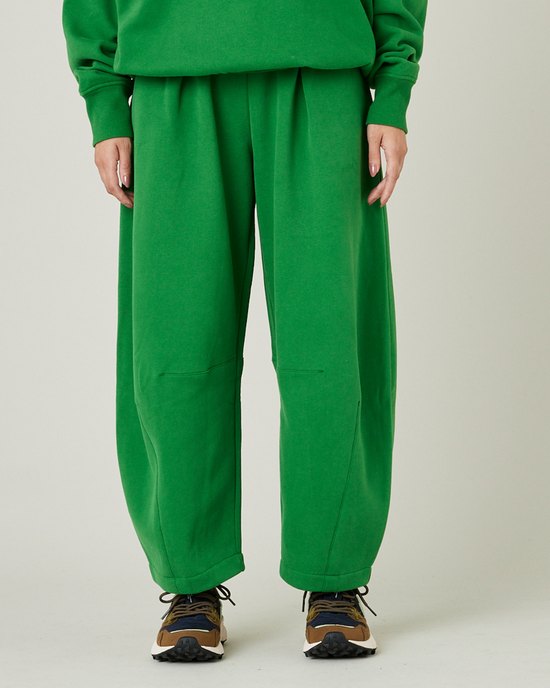 model wears juniper green daisy jersey trousers front