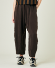 model wears espresso cupro mabel trousers front