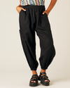 model wears black linen yoli trousers front