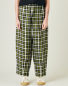 model wears olive black and ecru checked huxley trousers front