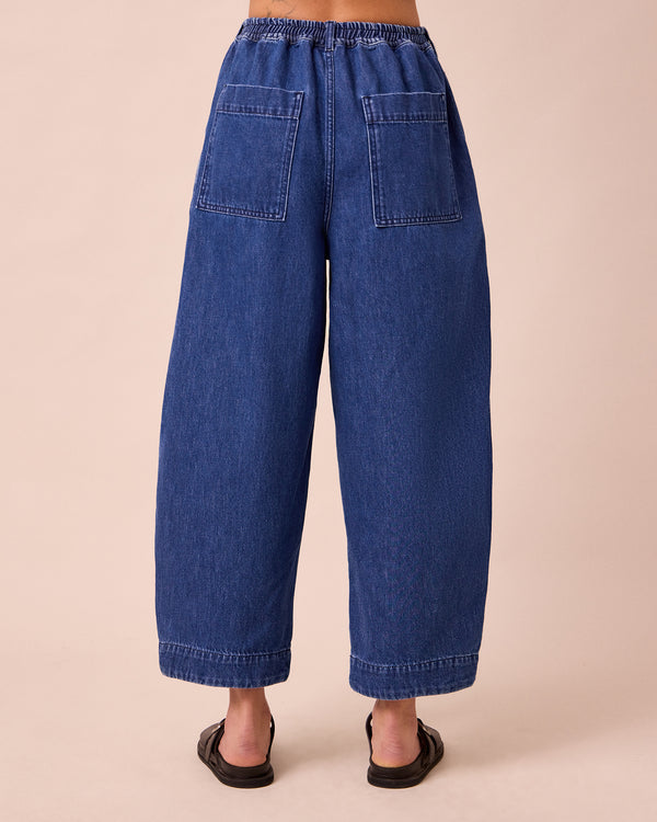 model wears vedamid blue denim jeans back