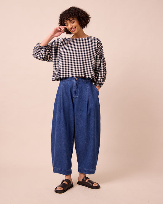 model wears veda mid blue denim jeans left