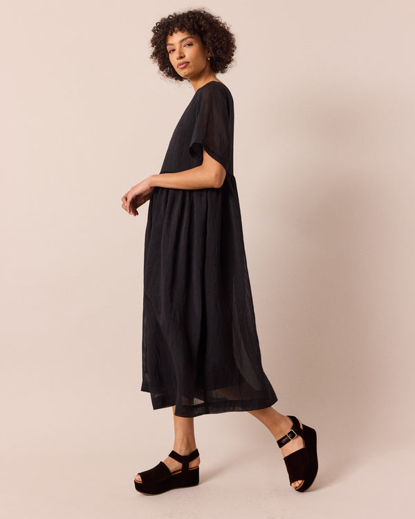 model wears verona black sheer stripe dress