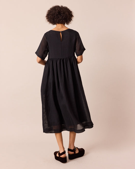 model wears verona black sheer stripe dress