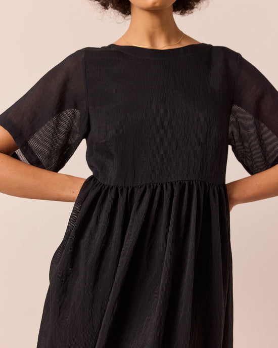 model wears verona black sheer stripe dress