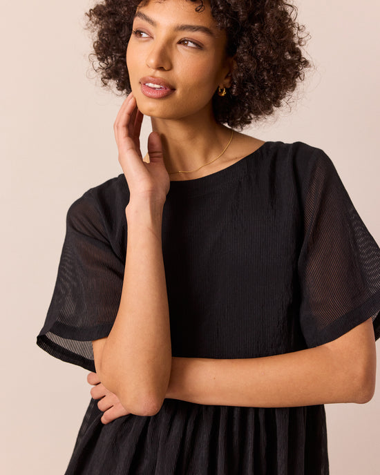 model wears verona black sheer stripe dress