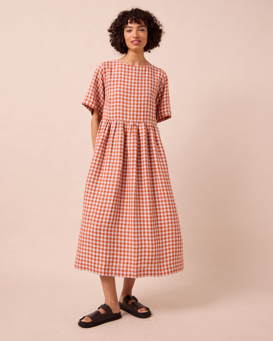 model wears verona burnt orange gingham linen dress
