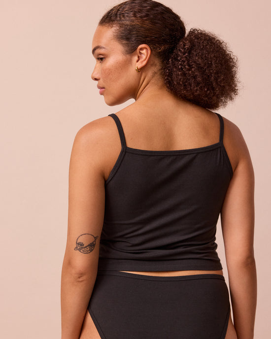 model wears black jersey vest