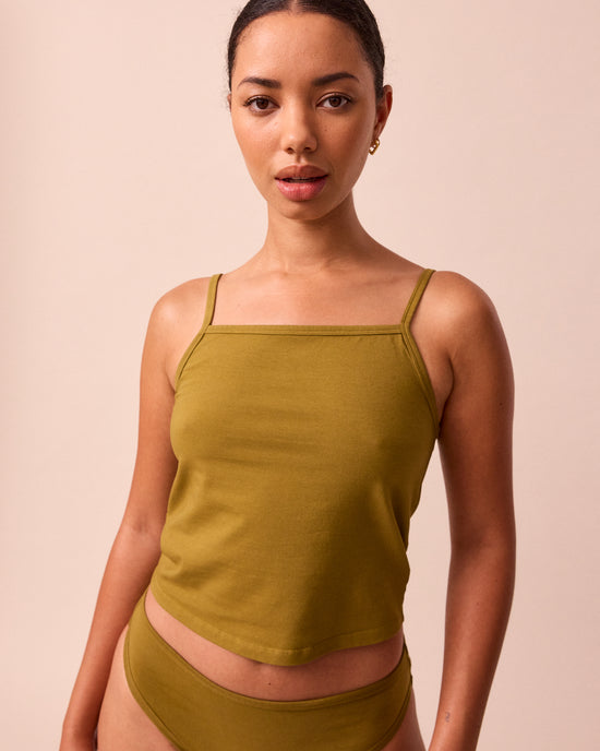 model wears golden olive jersey vest top
