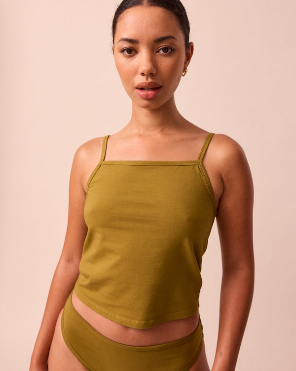 model wears golden olive jersey vest top