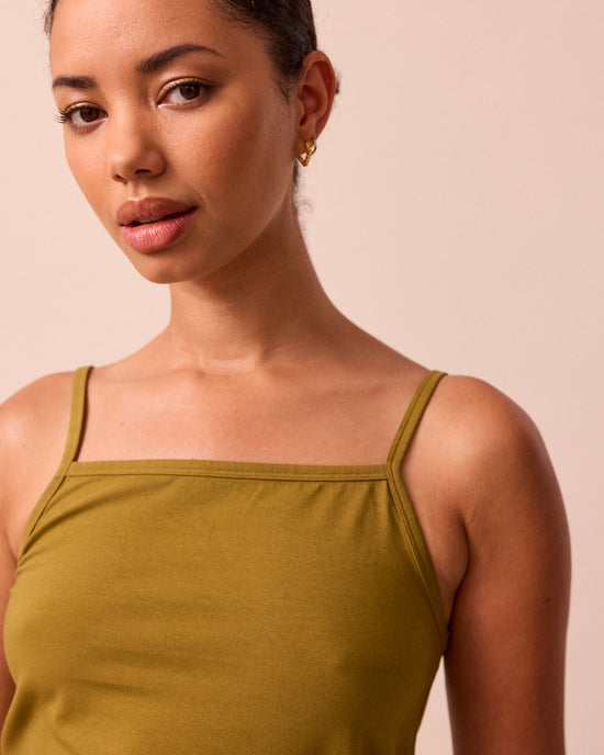 model wears golden olive jersey vest top