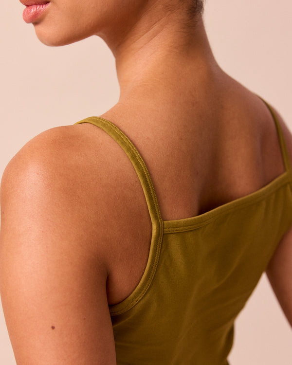 model wears golden olive jersey vest top