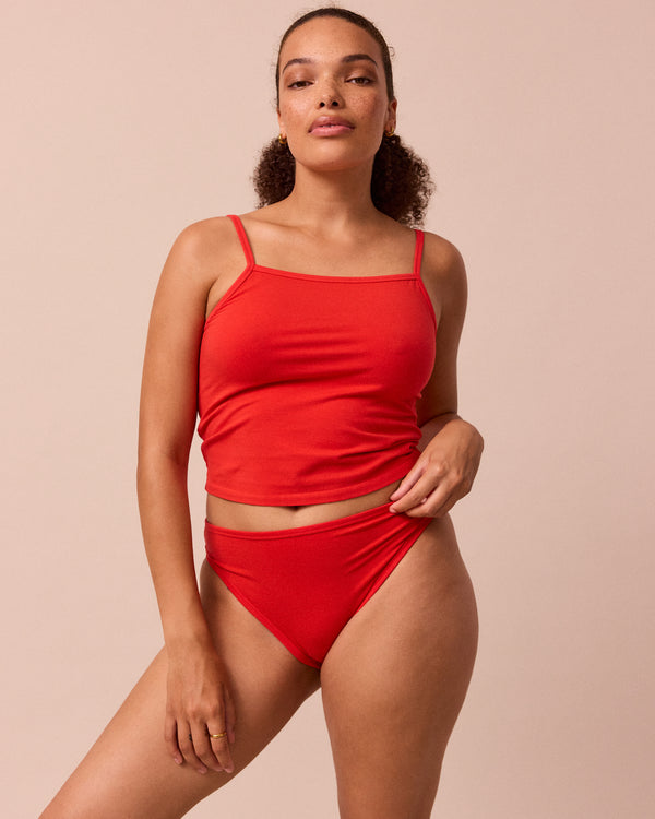 model wears tomato red jersey vest