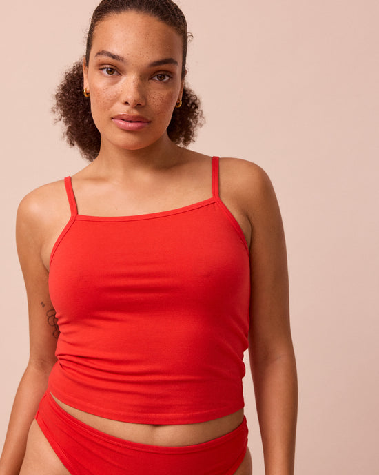 model wears tomato red jersey vest