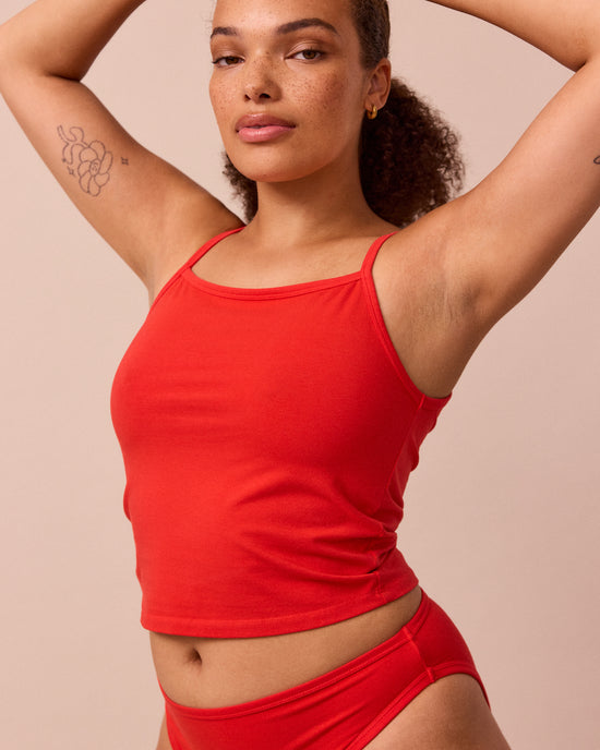 model wears tomato red jersey vest